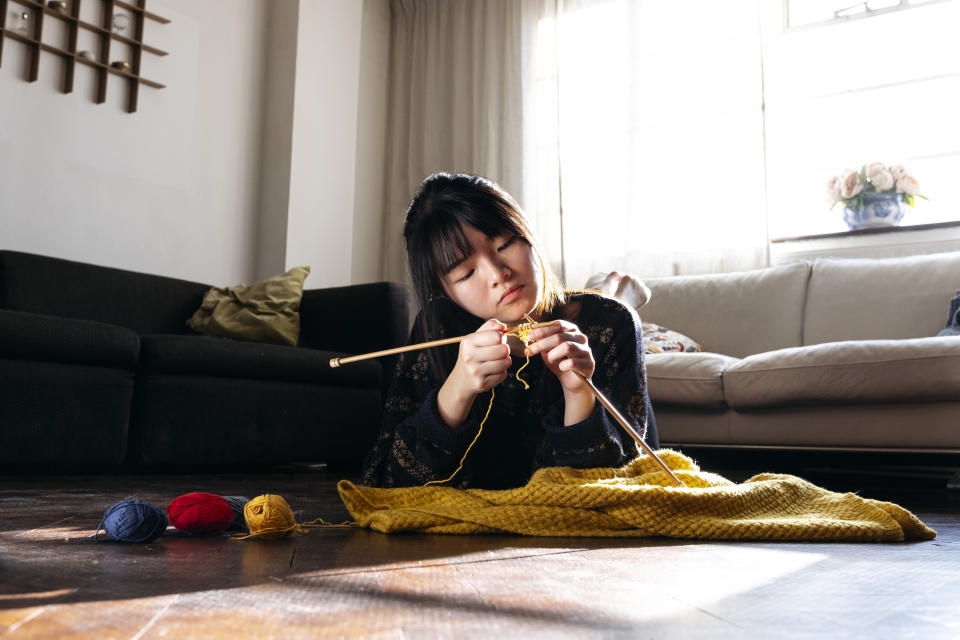 A young woman knitting