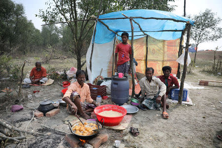 A man cooks a meal in his makeshift restaurant in the Vashan Char, previously known as Thengar Char island in the Bay of Bengal, Bangladesh February 14, 2018. REUTERS/Stringer