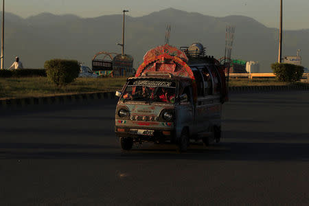 A vehicle drives along a road in Rawalpindi, Pakistan, April 30, 2016. REUTERS/Faisal Mahmood