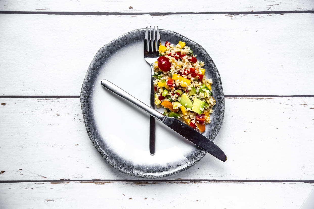 Bulgar salad on round plate, symbol for intermittent  fasting