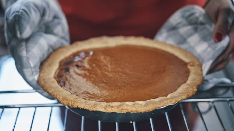 Fresh pumpkin pie out of oven