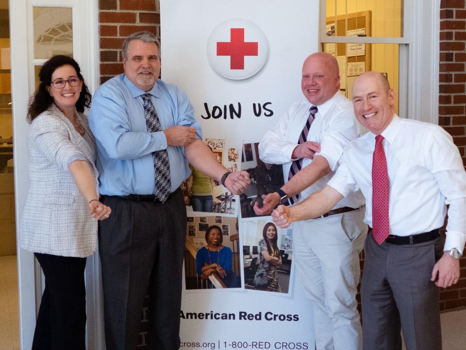 Stephanie Couturier, regional chief executive officer of the American Red Cross, left, with Dover City Manager Michael Joyal, Newmarket Town Manager Steve Fournier, and Durham Town Administrator Todd Selig. The leaders are rolling up their sleeves to promote a friendly blood-drive competition between their towns.