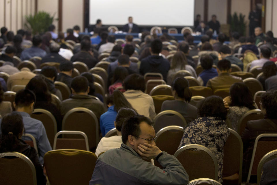 Relatives of Chinese passengers aboard the missing Malaysia Airlines flight MH370 attend a meeting with the Malaysian ambassador to China and a representative of Malaysia Airlines in Beijing, China, Monday, March 24, 2014. Rain was expected to hamper the hunt Monday for debris suspected of being from the missing Malaysia Airlines jet, as the United States prepared to move a specialized device that can locate black boxes into the south Indian Ocean region. (AP Photo/Ng Han Guan)