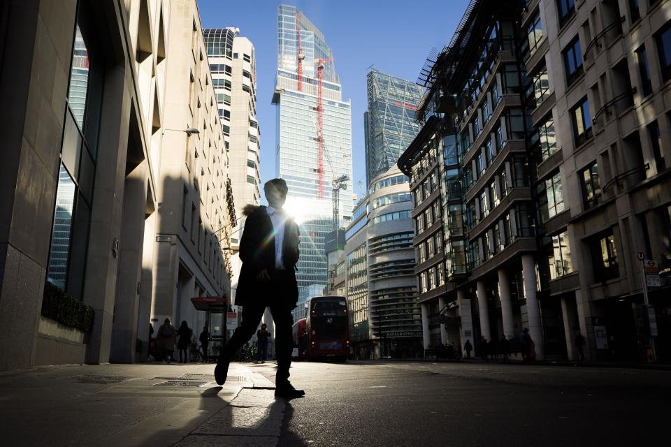 Person walking through Spitalfields, London. FTSE 100 was higher in London on Thursday