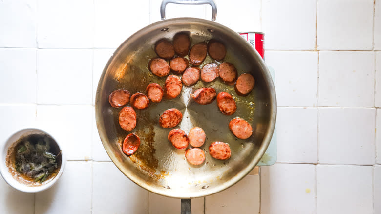 Smoked sausage browning in pan