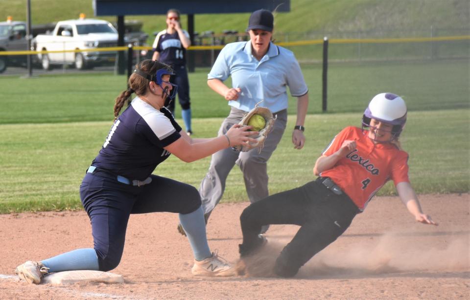 Central Valley Academy third baseman Elanah Elthorp-Rodriguez (left) reaches to tag a Mexico Academy runner out atempting to steal during Monday's Section III playoff game in Mohawk.