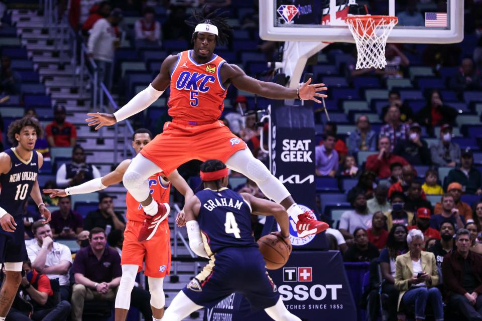 Oklahoma City's Luguentz Dort (5) tries to block a shot by New Orleans guard Devonte' Graham on Wednesday at Smoothie King Center in New Orleans.