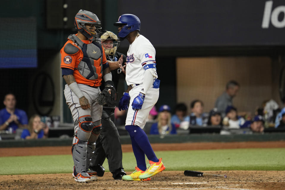 Texas Rangers' Adolis Garcia, right, yells at Houston Astros catcher Martin Maldonado after being hit by a pitch during the eighth inning in Game 5 of the baseball American League Championship Series Friday, Oct. 20, 2023, in Arlington, Texas. (AP Photo/Godofredo A. Vásquez)