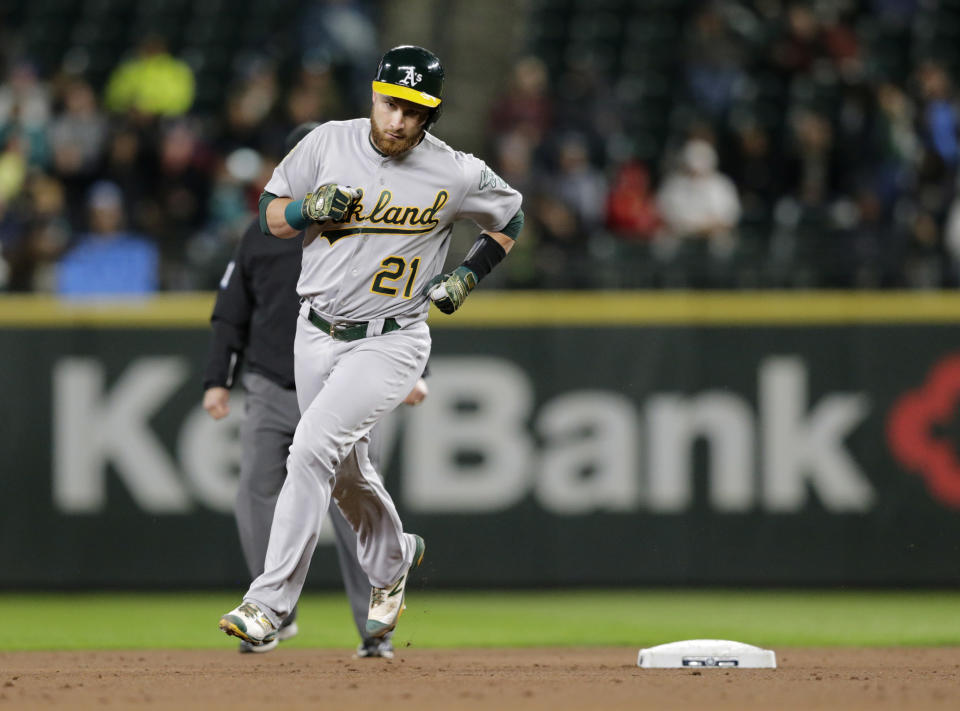 Oakland Athletics' Jonathan Lucroy rounds second after hitting a solo home run on a pitch from Seattle Mariners starting pitcher James Paxton during the third inning of a baseball game, Monday, Sept. 24, 2018, in Seattle. (AP Photo/John Froschauer)