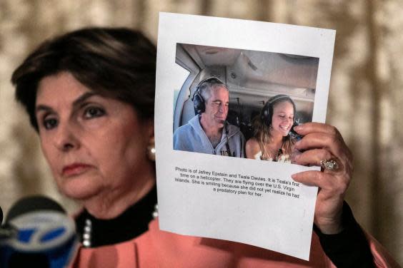 Gloria Allred shows a press conference a photo of Jeffrey Epstein and her client Teala Davies (AP)