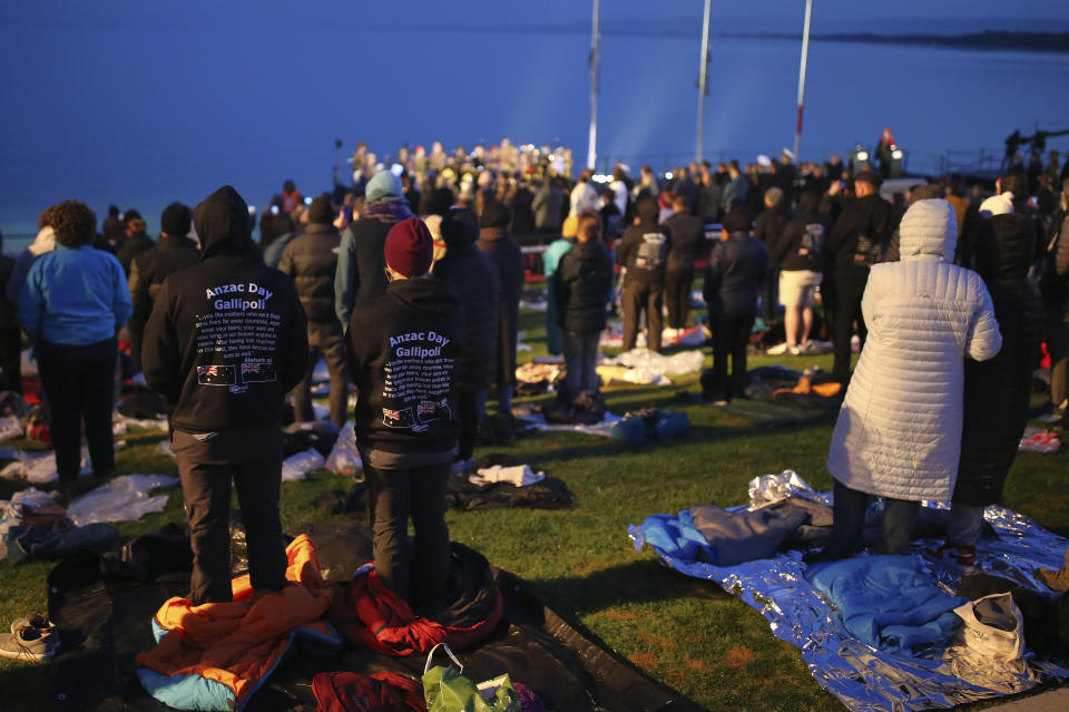 Visitors attend the Dawn Service ceremony at the Anzac Cove beach, the site of the April 25, 1915, World War I landing of the ANZACs (Australian and New Zealand Army Corps) on the Gallipoli peninsula, Turkey, early Monday, April 25, 2022. Travelers from Australia and New Zealand joined Turkish and other nations' dignitaries at the former World War I battlefields for a dawn service Monday to remember troops killed during an unsuccessful British-led campaign that aimed to take the Ottoman Empire out of the war. (AP Photo/Emrah Gurel)