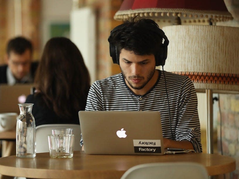 man working headphones laptop