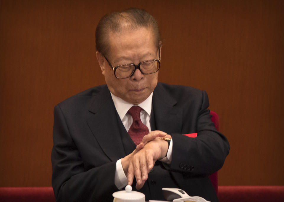 FILE - Former Chinese President Jiang Zemin checks his wristwatch during the opening session of China's 19th Party Congress in Beijing, Oct. 18, 2017. Chinese state TV said Wednesday, Nov. 30, 2022, that Jiang has died at age 96. (AP Photo/Mark Schiefelbein, File)