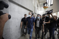 Shmulik Peleg, maternal grandfather of Eitan Biran, who survived a cable car crash in Italy that killed his immediate family, leaves court in Tel Aviv on Thursday, Sept. 23, 2021 for a hearing on charges of kidnapping his grandson. The boy's parents and younger sibling were among 14 killed in May when a cable car slammed into a mountainside in northern Italy. He is now the focus of a custody battle between his maternal grandparents in Israel and his paternal relatives in Italy. (AP Photo/Sebastian Scheiner)