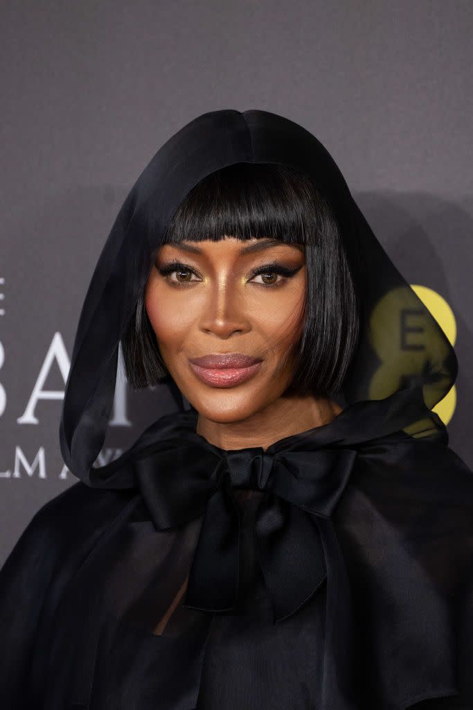 naomi campbell at the 2024 ee bafta film awards arrivals with a short black bob and veil