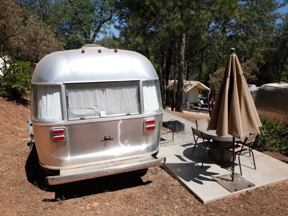 Outside the Airstream next to picnic tables