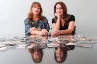 Cady Evans (L) and her sister Crystal Deckard hold an old photograph as they reminisce on the loss of their mother in California, U.S. August 15, 2018. Picture taken August 15, 2018. REUTERS/Mike Blake