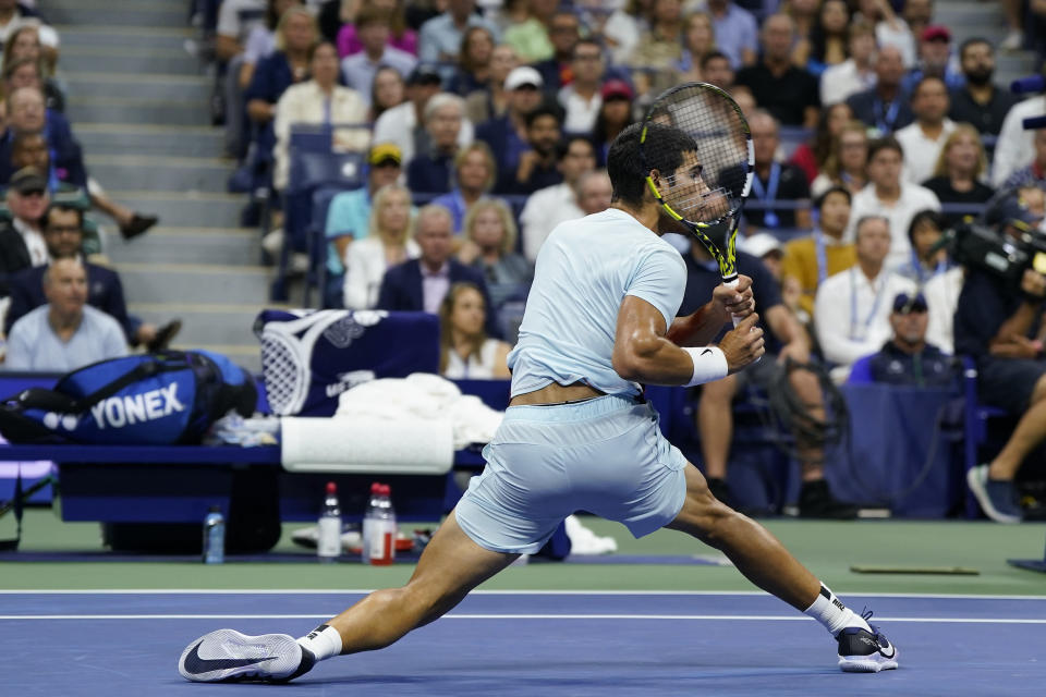Carlos Alcaraz, of Spain, returns a shot at the net to Frances Tiafoe, of the United States, during the semifinals of the U.S. Open tennis championships, Friday, Sept. 9, 2022, in New York. (AP Photo/John Minchillo)