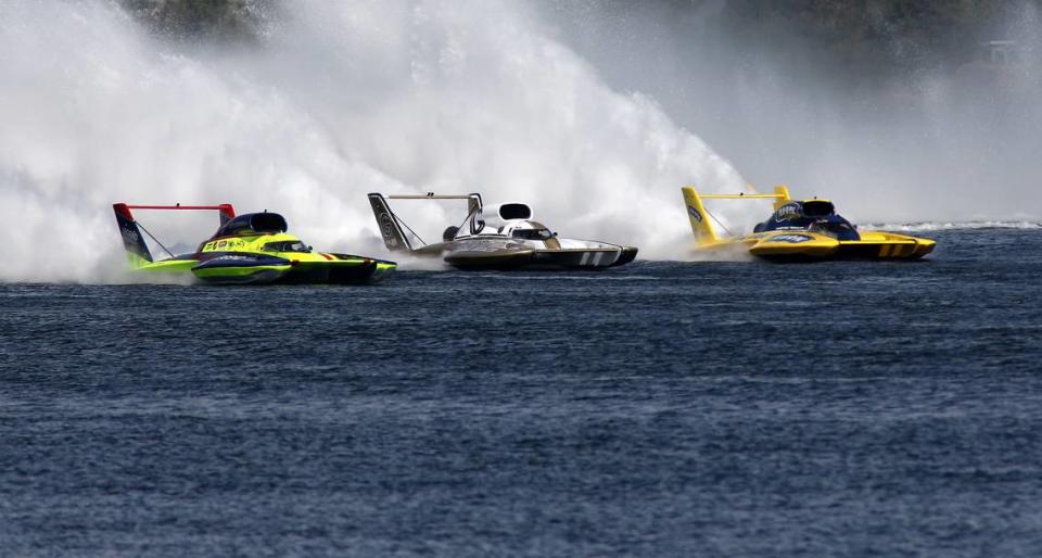 Unlimited hydroplane drivers Jamie Nilsen, Andrew Tate and Dustin Echols are deck-to-deck exiting turn four during their heat 2A race of the Columbia Cup early Sunday morning on the 2023 Columbia River. Tate pulled away from his competitors to win.