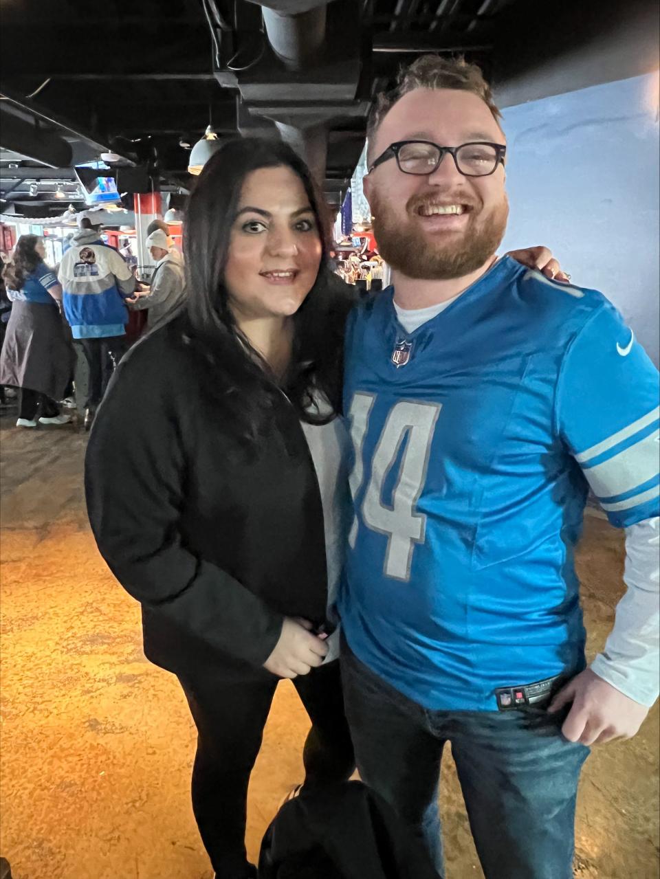Donna Yaldo, 39, and Nate Bazyldo, 28, pose for a photo at a pregame event in Comerica Park on Sunday, Jan. 21, 2024, ahead of the Detroit Lions vs. Tampa Bay Buccaneers playoff game. Comerica Park hosted both a pregame event and a free watch party for the game.