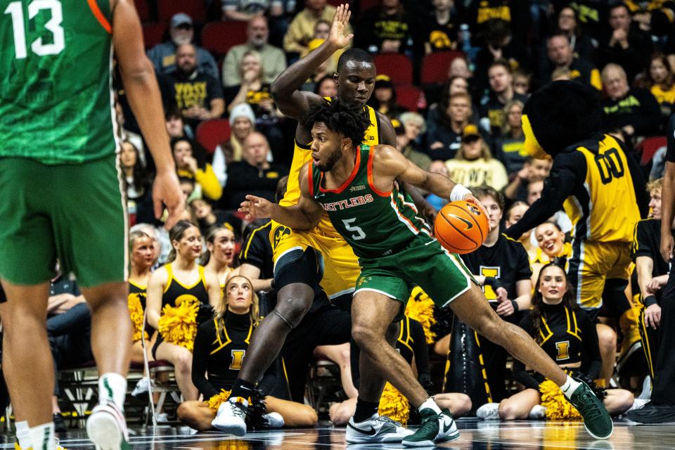 Florida A&M's Keith Lamar drives to the basket against Iowa's Ladji Dembele during the Hawkeye Showcase at Wells Fargo Arena on Saturday, Dec. 16, 2023, in Des Moines.