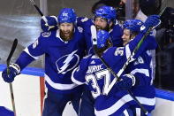 Tampa Bay Lightning left wing Ondrej Palat (18) celebrates after scores the winning goal on the Boston Bruins with teammates Braydon Coburn (55), Patrick Maroon (14) and Yanni Gourde (37) during overtime of an NHL Stanley Cup Eastern Conference playoff hockey game in Toronto, Ontario, Tuesday, Aug. 25, 2020. (Frank Gunn/The Canadian Press via AP)