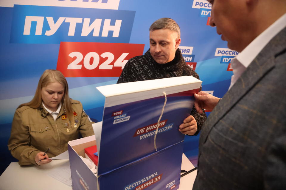 Volunteers count votes for Vladimir Putin. (AP)