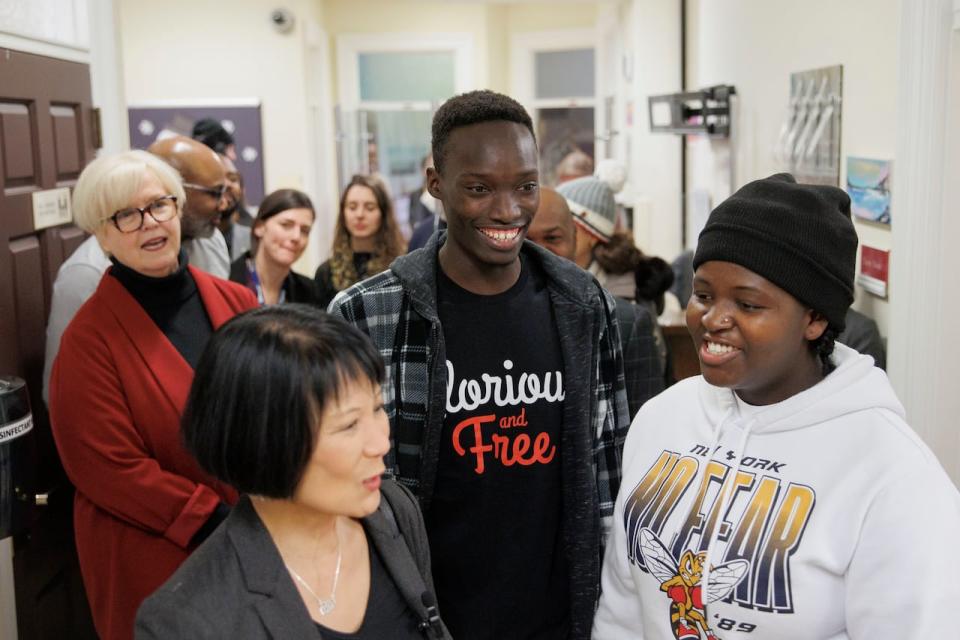 Job Gori, 22, middle, and Victoria Kwamboka, 19, right, guide Toronto Mayor Olivia Chow on a tour of Covenant House Toronto on Jan. 15, 2024.
