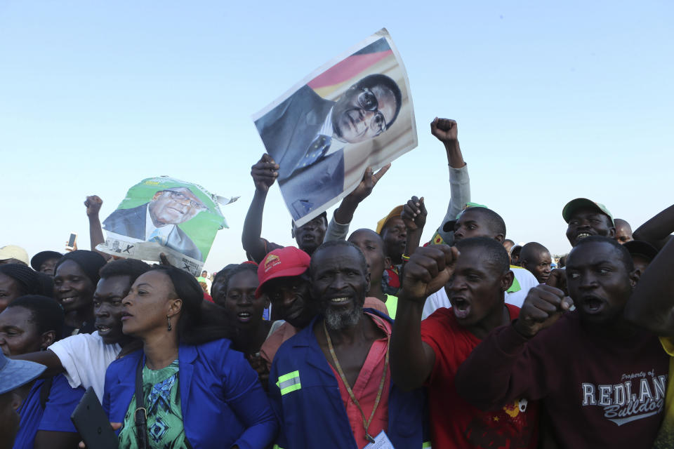 Supporters of Zimbabwe's former ruler, Robert Mugabe react upon the arrival of his remains at at RG Mugabe airport in Harare,Wednesday, Sept, 11, 2019.(AP Photo/Tsvangirayi Mukwazhi)