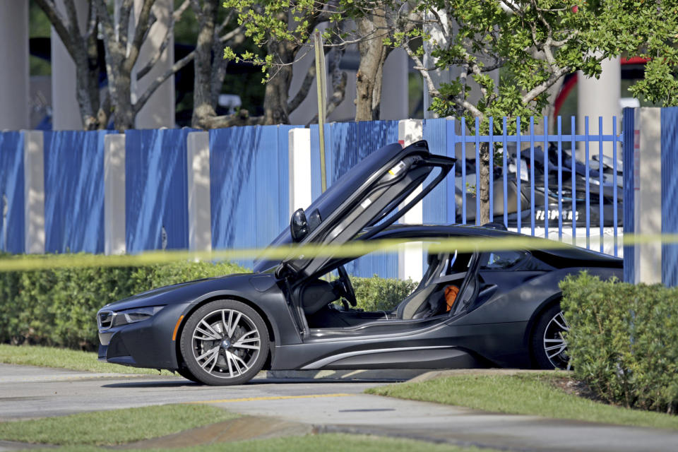 FILE - An empty vehicle appears on a street where rapper XXXTentacion was shot on Monday, June 18, 2018, in Deerfield Beach, Fla. More than four years after gunmen killed the emerging rap star XXXTentacion during a robbery outside a South Florida motorcycle shop, three suspects are about to go on trial. Jury selection begins Wednesday, Jan. 18, 2023, in Fort Lauderdale. Alleged shooter Michael Boatwright and his accused accomplices, Dedrick Williams and Trayvon Newsome, could all receive life sentences if convicted of first-degree murder. (John McCall/South Florida Sun-Sentinel via AP, File)