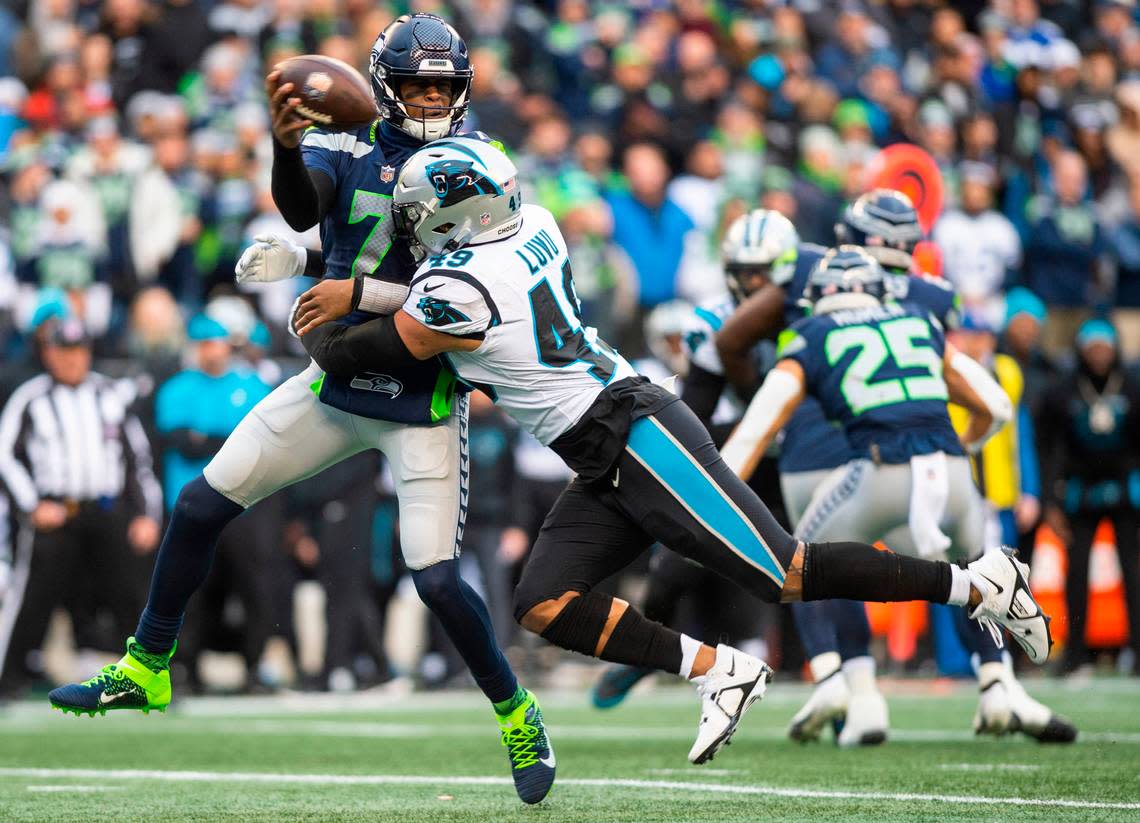 Seattle Seahawks quarterback Geno Smith (7) is sacked by Carolina Panthers linebacker Frankie Luvu (49) in the second quarter of an NFL game at Lumen Field in Seattle Wash., on Dec. 11, 2022.