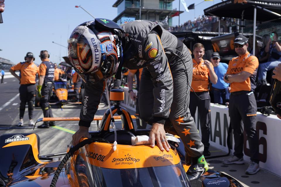 Tony Kanaan, of Brazil, climbs into his car during final practice for the Indianapolis 500 auto race at Indianapolis Motor Speedway, Friday, May 26, 2023, in Indianapolis. (AP Photo/Darron Cummings)