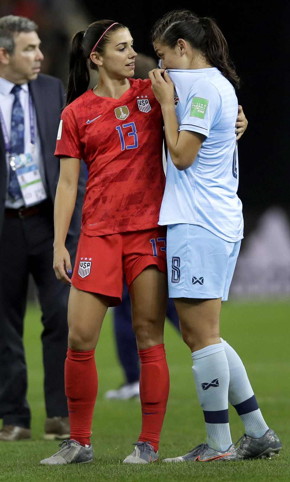 United States' Alex Morgan, left, comforts Thailand's Miranda Nild, right, after the Women's World Cup Group F soccer match between United States and Thailand at the Stade Auguste-Delaune in Reims, France, Tuesday, June 11, 2019. Morgan scored five goals during the match. (AP Photo/Alessandra Tarantino)