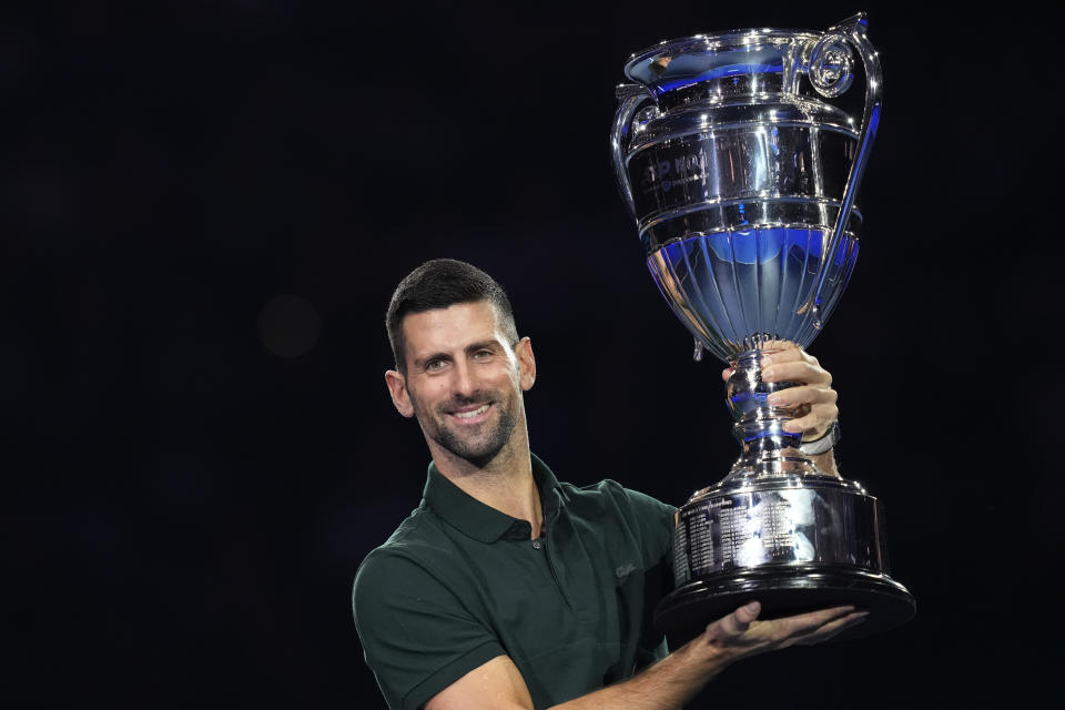 Serbia's Novak Djokovic holds the trophy as ATP world best player at the ATP World Tour Finals, at the Pala Alpitour, in Turin, Italy, Monday, Nov. 13, 2023. Djokovic was presented with the trophy for finishing the year ranked No. 1. (AP Photo/Antonio Calanni)