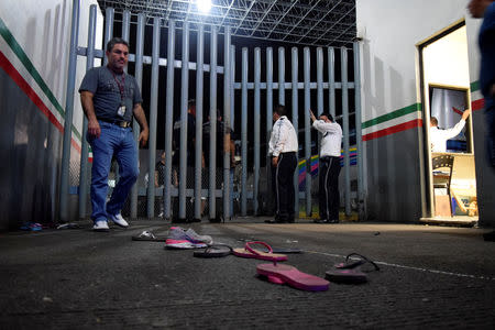 Private security guards are seen at the gate of the Siglo XXI immigrant detention center after a large group of Cubans, Haitians and Central Americans broke out and escaped the facilities, in Tapachula, Mexico April 25, 2019. REUTERS/Jose Torres