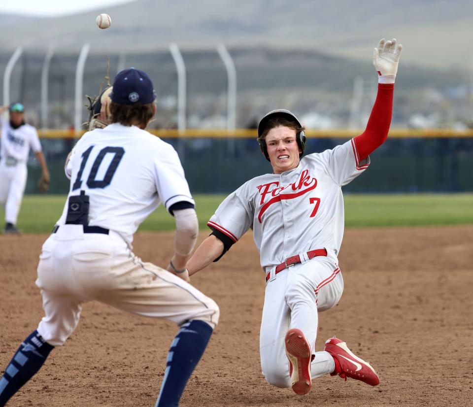 American Fork’s Ryder Robinson (7) steals third base before getting tagged by Westlake’s Mason Hartle (10) at Westlake High in Saratoga Springs on Thursday, April 27, 2023. | Laura Seitz, Deseret News