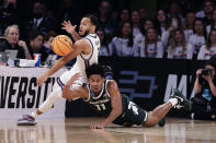 Michigan State guard A.J. Hoggard (11) and Kansas State guard Markquis Nowell (1) reach for the loose ball in the second half of a Sweet 16 college basketball game in the East Regional of the NCAA tournament at Madison Square Garden, Thursday, March 23, 2023, in New York. (AP Photo/Adam Hunger)