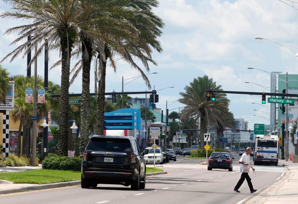 A pedestrian crosses Atlantic Avenue in Daytona Beach, Monday, July 11, 2022. 