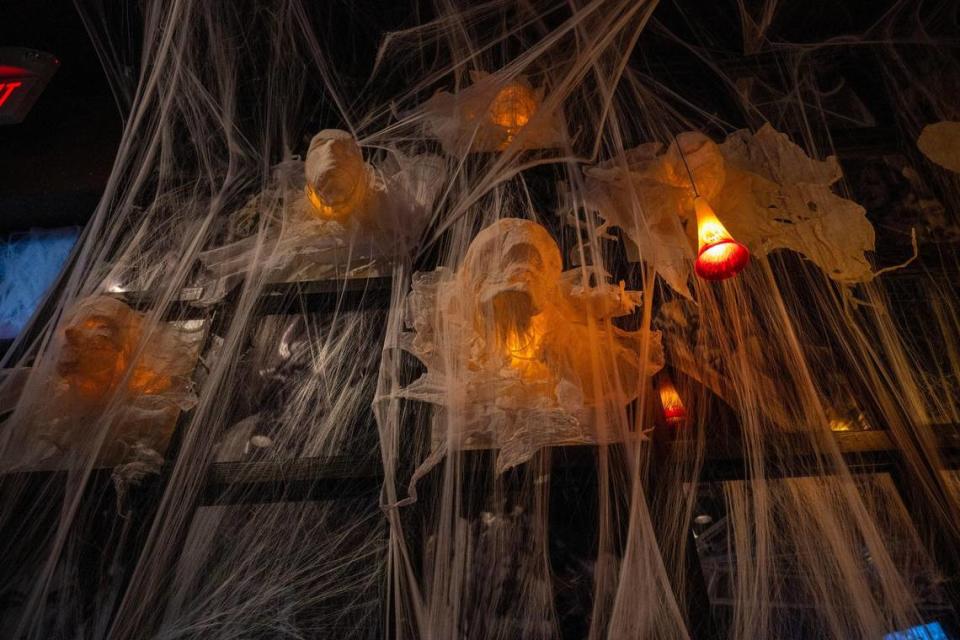 Decorative ghost heads and cobwebs hover on the mirror above the bar at Cafe Trio, where Halloween decorations are only surpassed by the Christmas decorations.