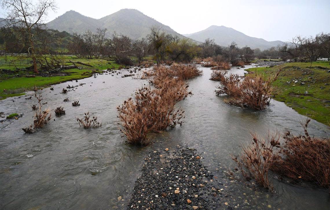 Mill Creek enters Wonder Valley as it flows from Tretten Canyon, seen from the bridge on Lupine Drive during a light rain Thursday, March 9, 2023 east of Fresno.