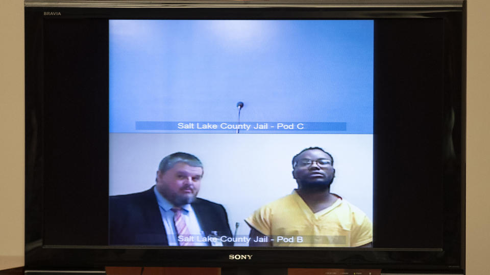 Attorney Neal Hamilton, left, stands with Ayoola A. Ajayi during his video preliminary hearing at the Matheson Courthouse Monday, July 15, 2019, in Salt Lake City. Ajayi, a tech worker charged in the death of a Utah college student, appeared by video from jail alongside a court-appointed attorney during a quick hearing to set a future court date. He did not speak or enter a plea to murder, kidnapping and other charges. (Steve Griffin/Deseret News, via AP Photo, Pool)