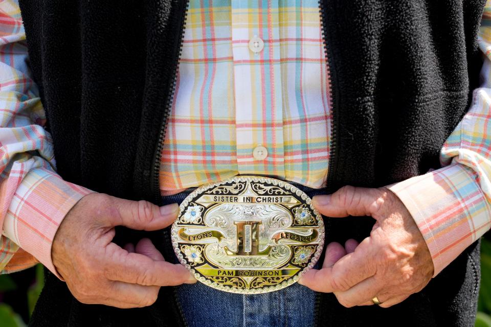 Pam Robinson’s most prized possession she’s been awarded is her “Sister in Christ” belt buckle she received as a gift from John Lyons.