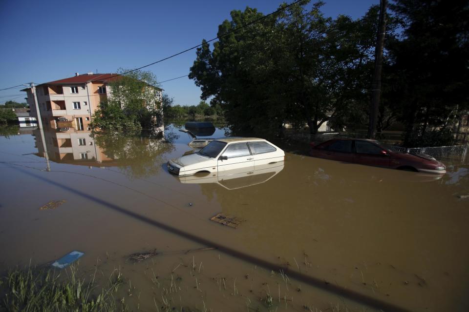 Damaged cars are seen stranded in flood waters in the town of Obrenovac