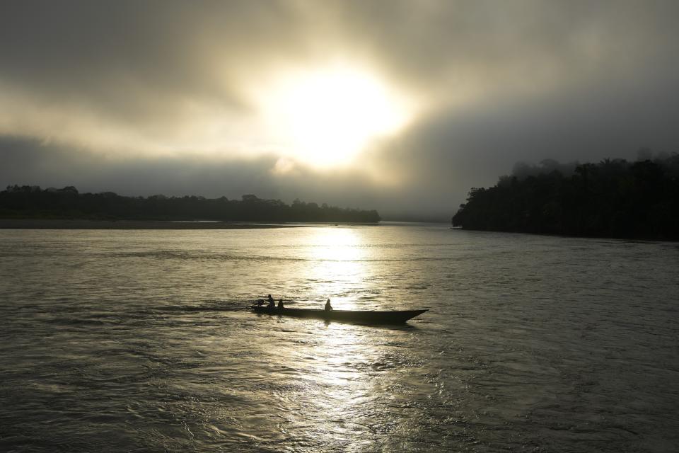 People traverse the Mantaro River at sunrise in Santa Maria de Nieva, Peru, Wednesday, June 26, 2024. (AP Photo/Martin Mejia)