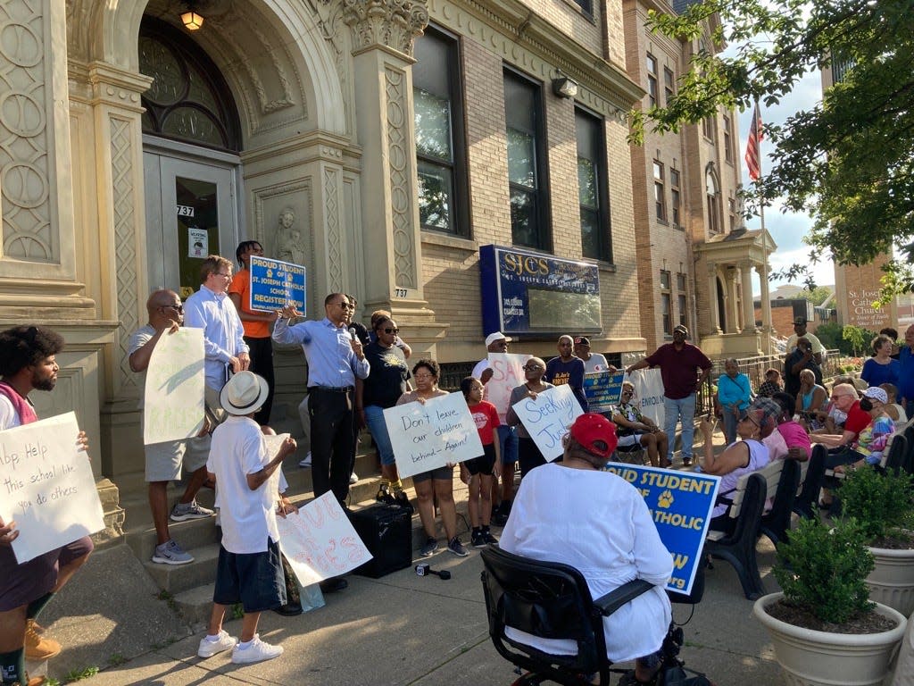 Alumni, students, parents and parish members gathered at St. Joseph Catholic School on Thursday evening to protest its closure.