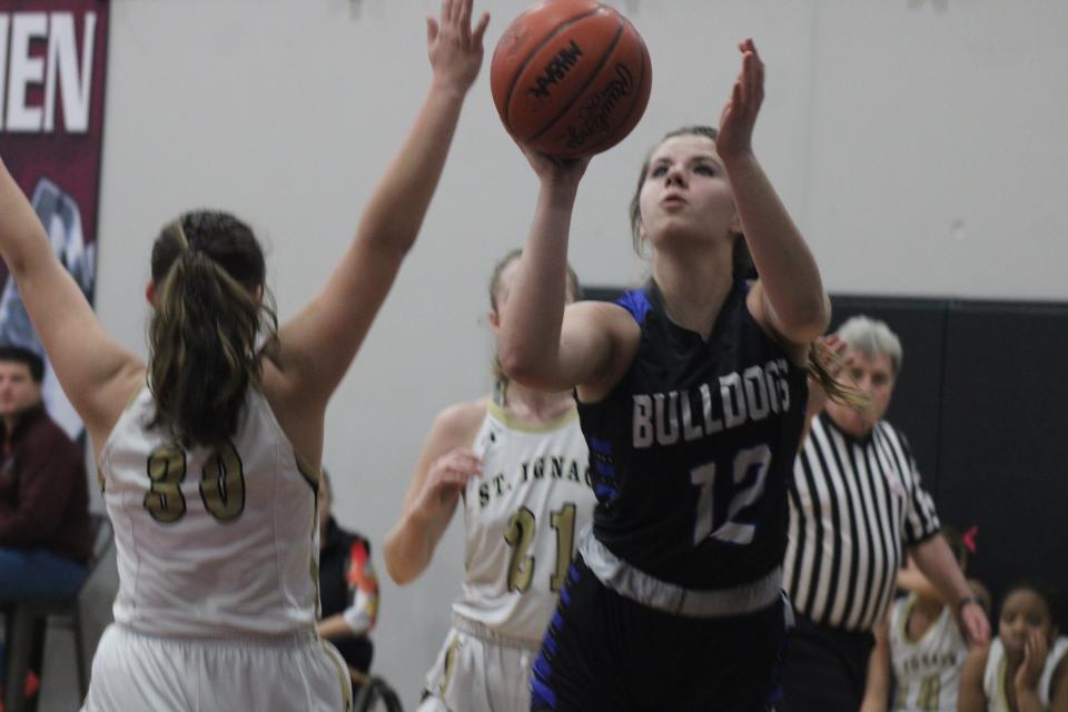 Inland Lakes sophomore Chloe Robinson (12) takes a shot during a MHSAA Division 4 regional girls basketball semifinal against St. Ignace at Harbor Light on Monday.