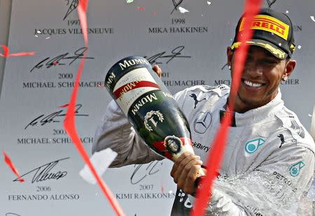 Mercedes Formula One driver Lewis Hamilton of Britain celebrates on the podium after winning the Italian F1 Grand Prix in Monza September 7, 2014. REUTERS/Max Rossi