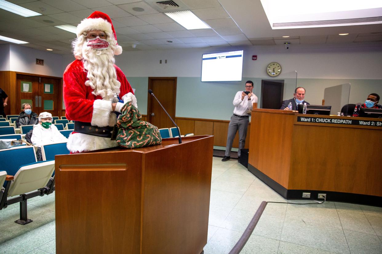 Santa Claus, portrayed by Rich Berning, explains that the loud boom everyone in Springfield heard Tuesday morning may have been caused by him as he stops by the Springfield City Council meeting Tuesday night. [Justin L. Fowler/The State Journal-Register]