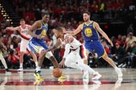 May 20, 2019; Portland, OR, USA; Golden State Warriors center Kevon Looney (5) and guard Klay Thompson (11) defend Portland Trail Blazers guard Damian Lillard (0) in the second half of game four of the Western conference finals of the 2019 NBA Playoffs at Moda Center. Mandatory Credit: Jaime Valdez-USA TODAY Sports