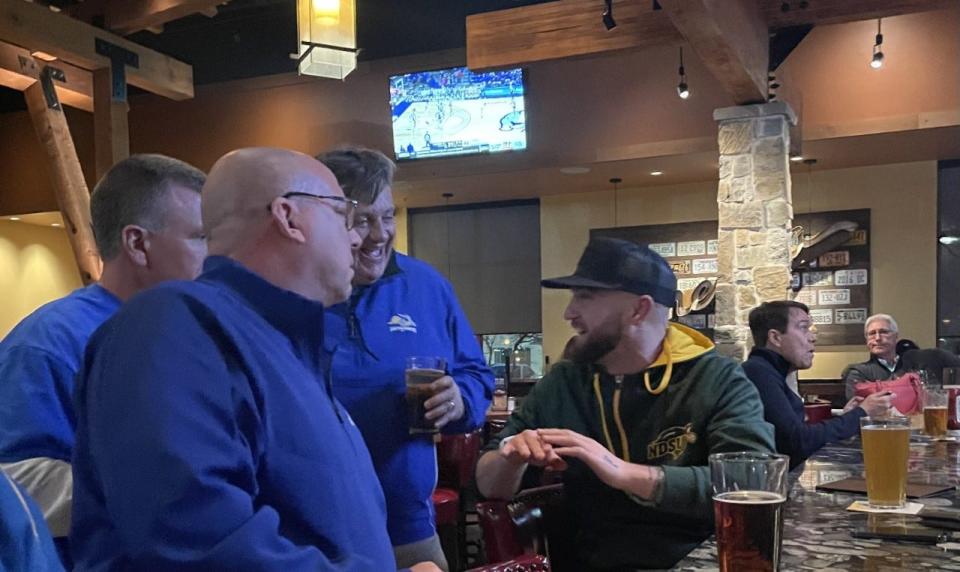 South Dakota State fans visit with a Bison fan Saturday night in Frisco.